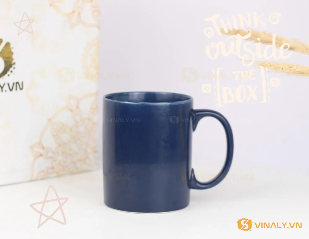 LY SỨ TRỤ MÀU XANH CỬU LONG - cốc màu xanh 8 Ly sứ trụ màu xanh cửu long in logo đặt trên nền trắng, phía sau là túi giấy và hình trang trí "Think outside the box".